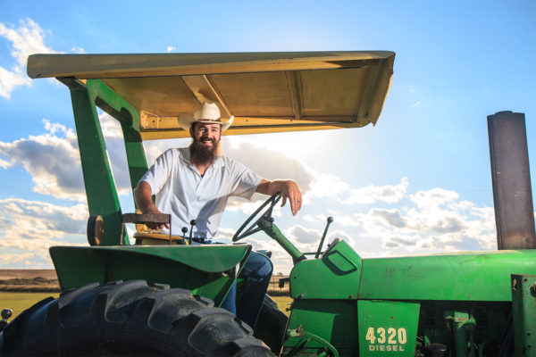 farmer sitting on a tractor