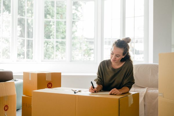 woman thinking about renters insurance as she packs